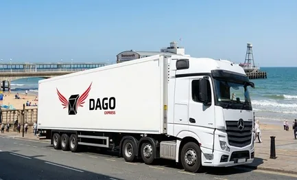 DAGO Express courier service truck in front of Bournemouth Pier and the sandy beach in Bournemouth