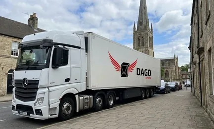 DAGO Express courier service truck in front of Crooked Spire of St Marys Church in Chesterfield