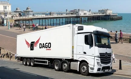 DAGO Express courier service truck in front of Worthing Pier and the seafront promenade in Worthing